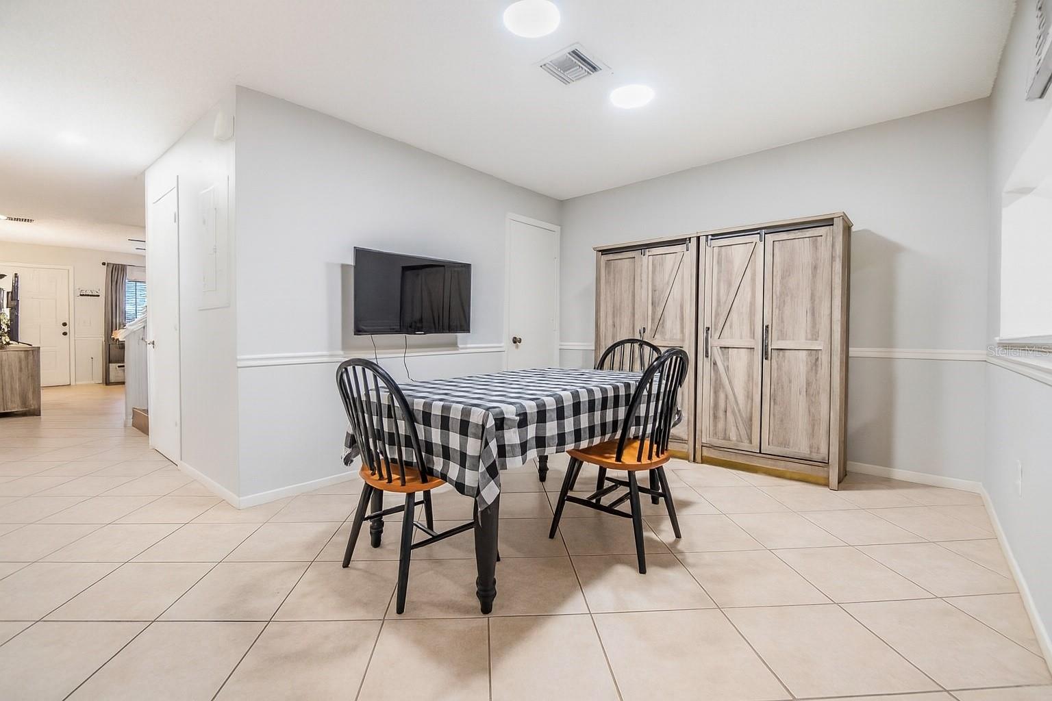 Formal Dining Room with deep walk-in storage closet under the stairs.