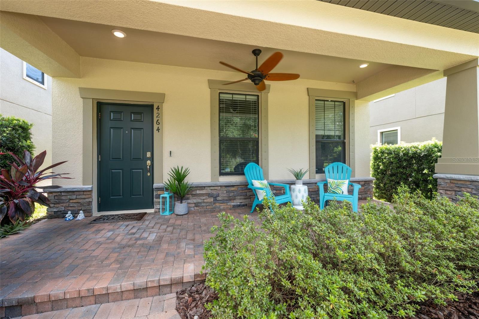 Tranquil front porch, with beautiful landscaping and water views.