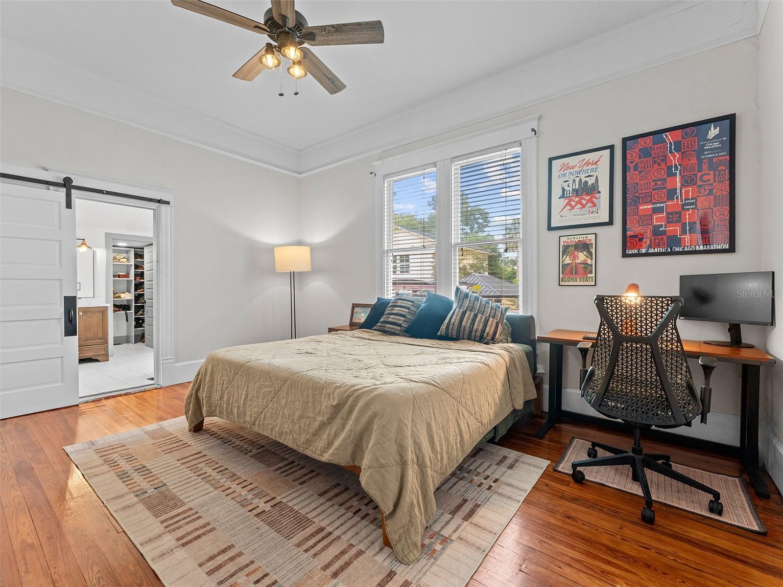 Large primary with barn door ; large ensuite bath and walk in closet