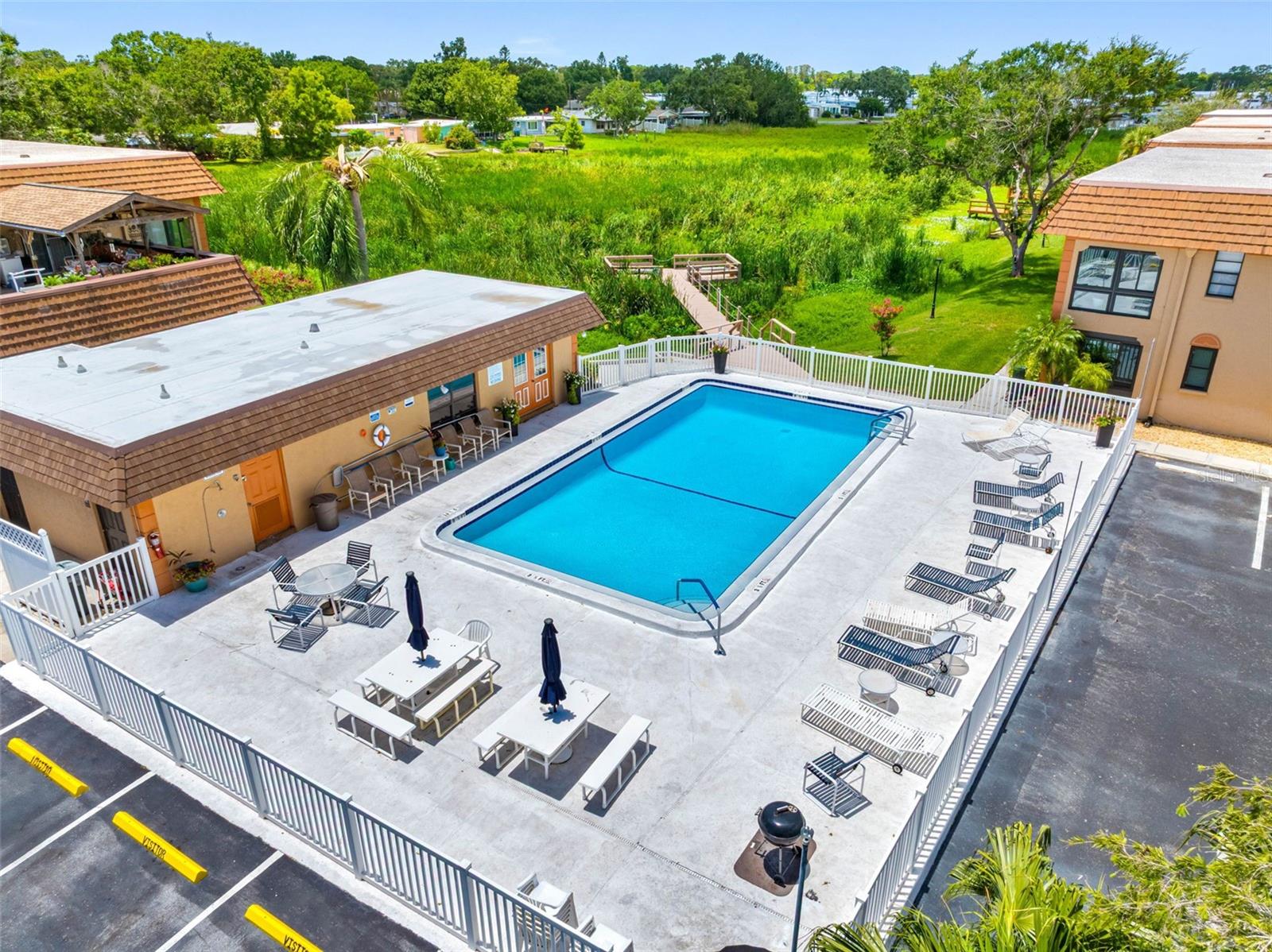 a resort-style community pool overlooking the lake, enhancing the relaxed waterfront lifestyle