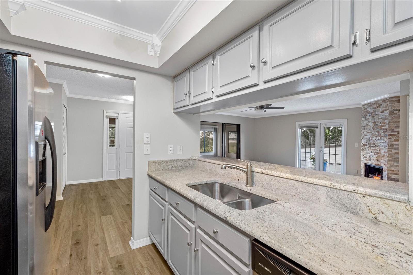 Kitchen with updated flooring and easy flow to outdoor living areas