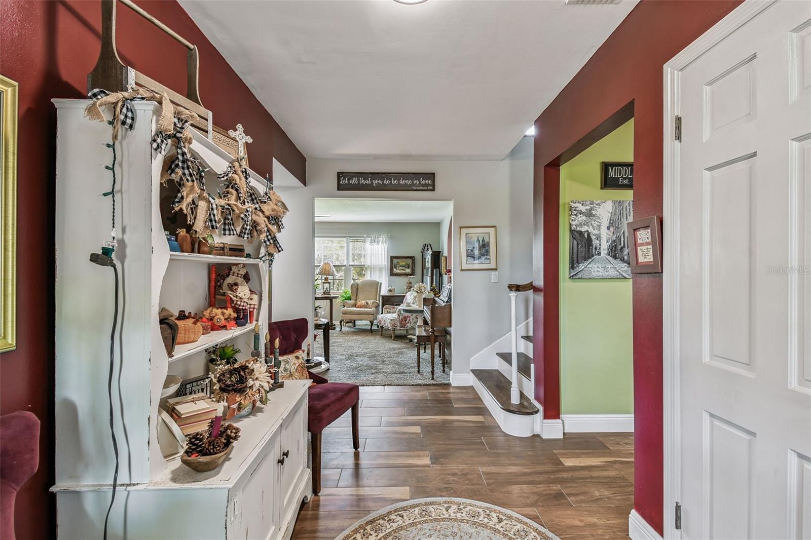 Entry.  To the left is Owner's suite and bath, half bath, and bedroom 2 with private bath.