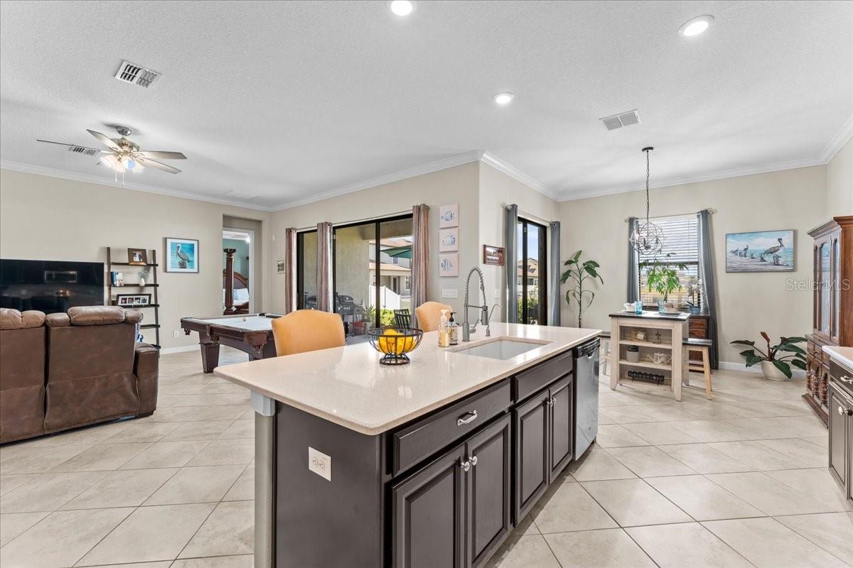 Large tile on diagonal throughout and sliders to patio from the eat in kitchen