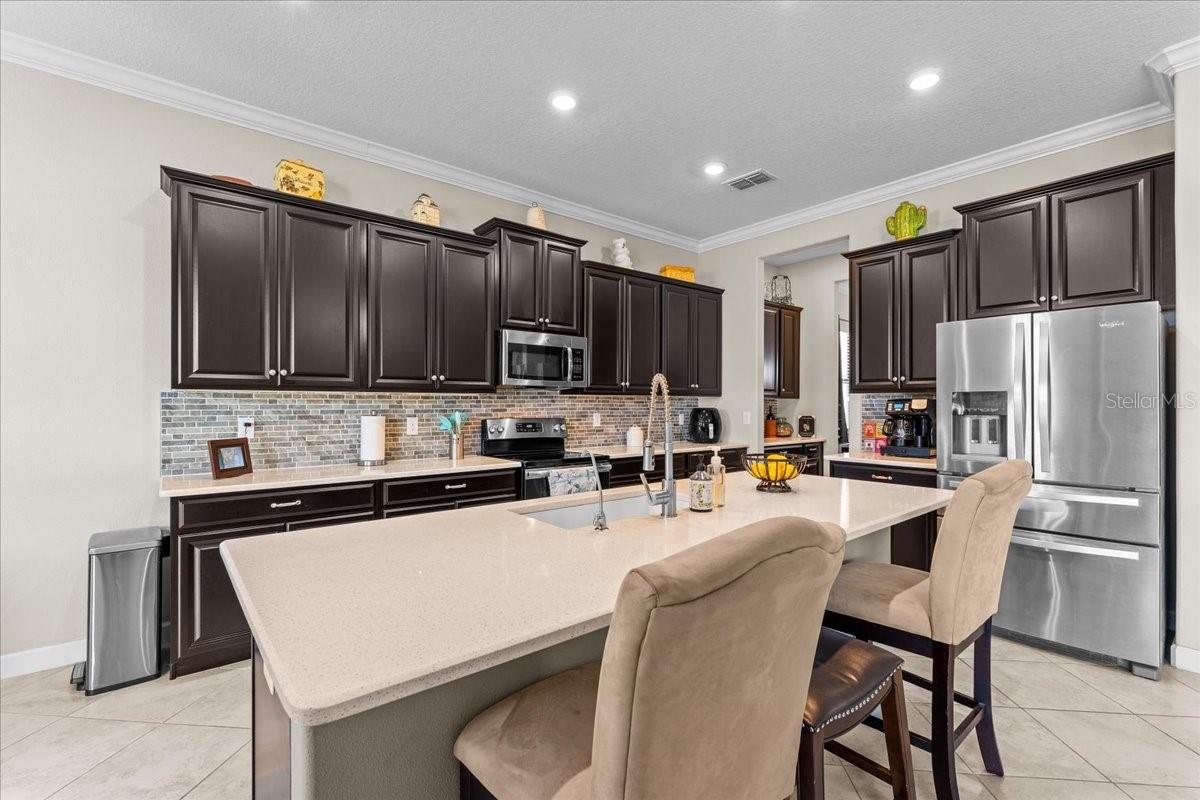 Wood Expresso cabinets and decorative back splash