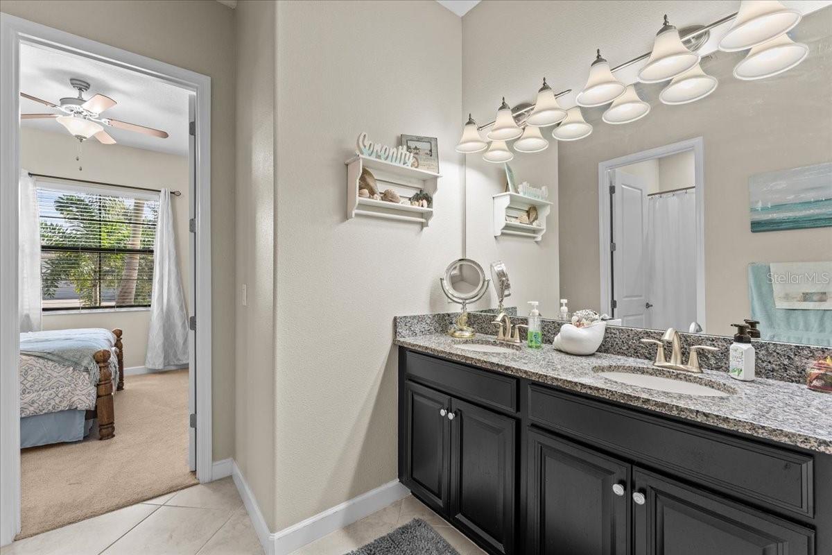 Jack and Jill bath with double sinks and separate water closet open to secondary bedroom 1 and 2