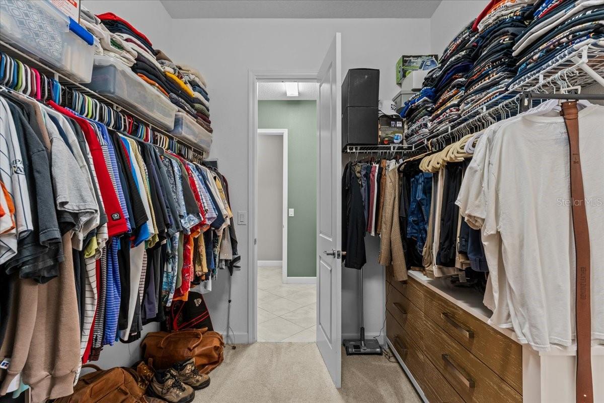 Walk in closet with access to laundry room.