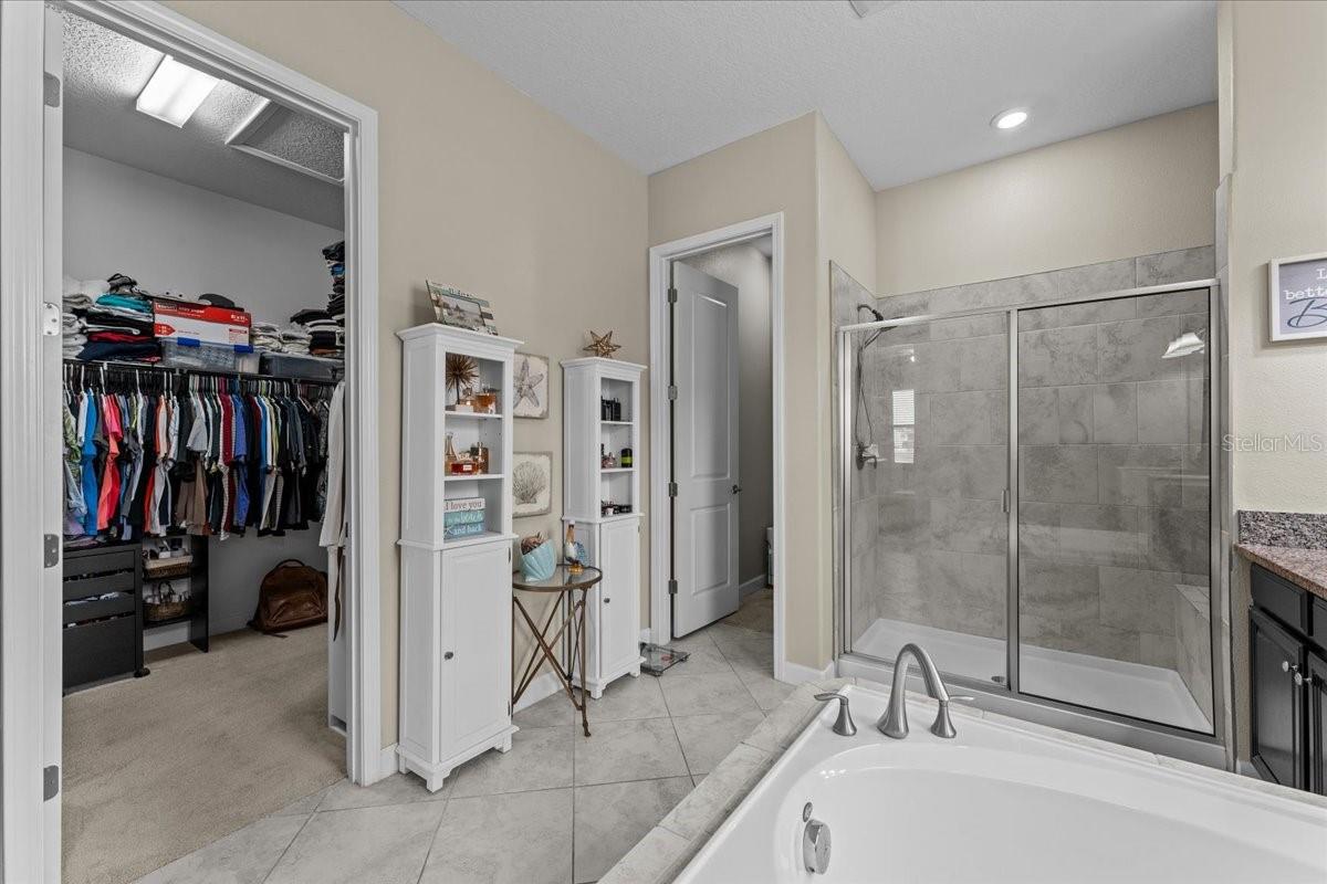 Huge walk in closet with door into the laundry room too!
