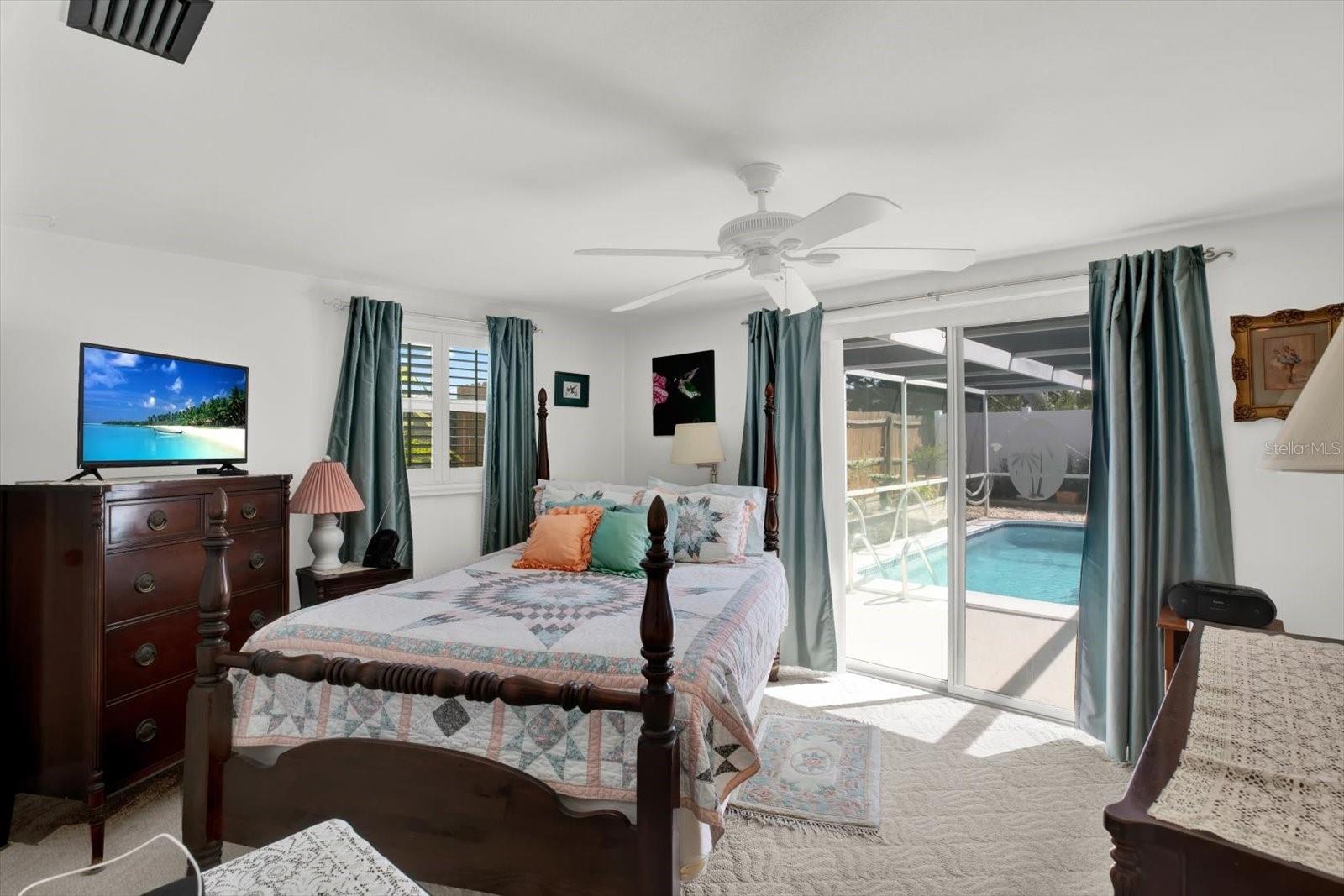 Primary bedroom with view to the pool.