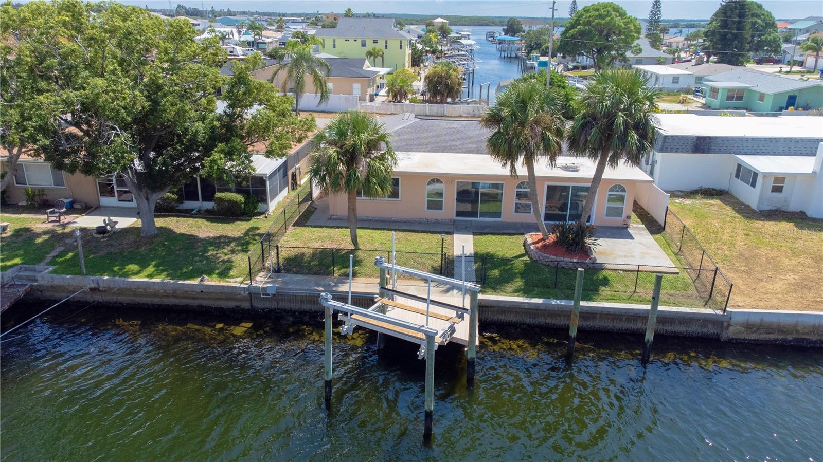 Rear aerial view With dock and boat lift.