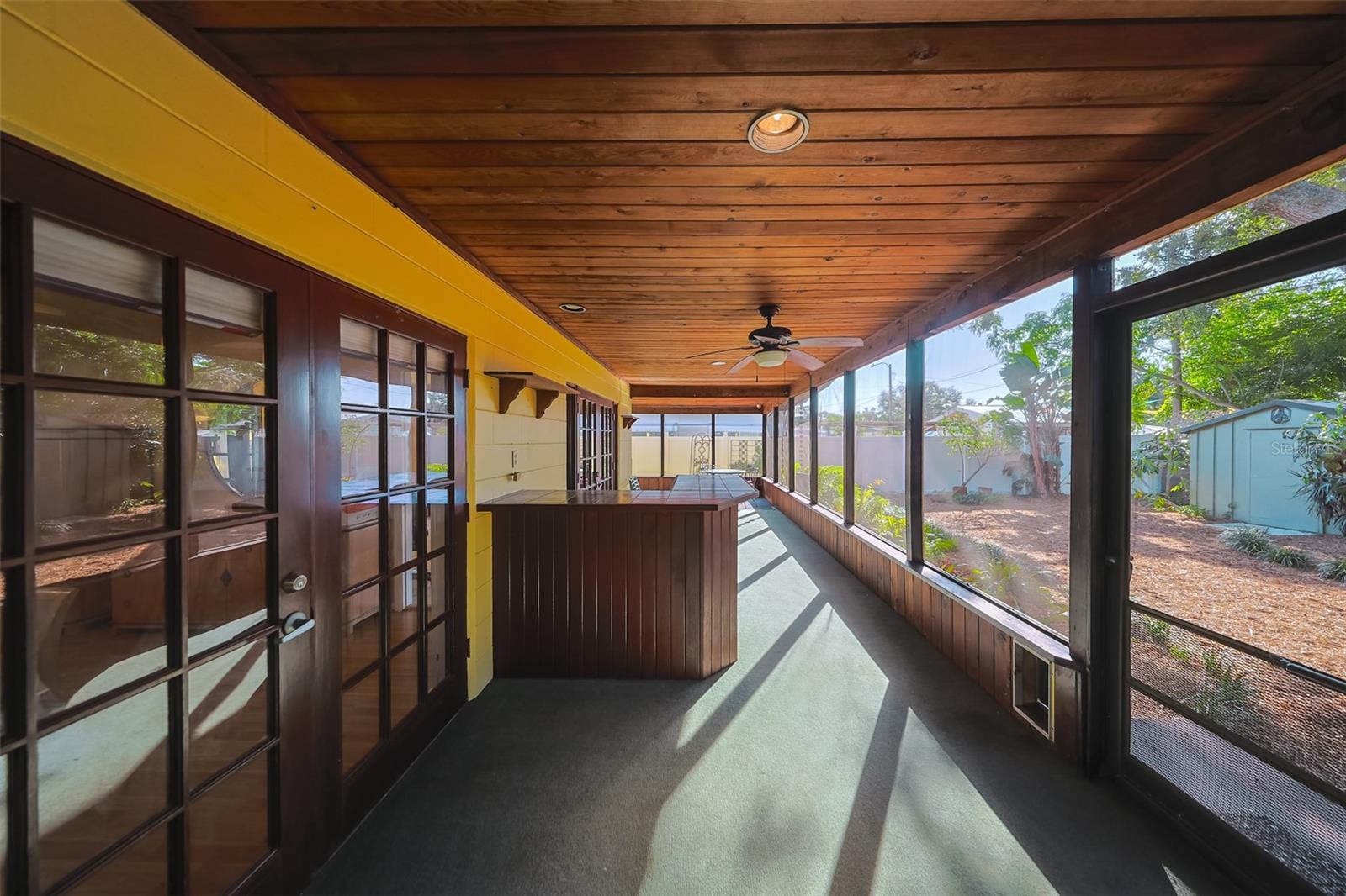 Screened in porch with a bar.
