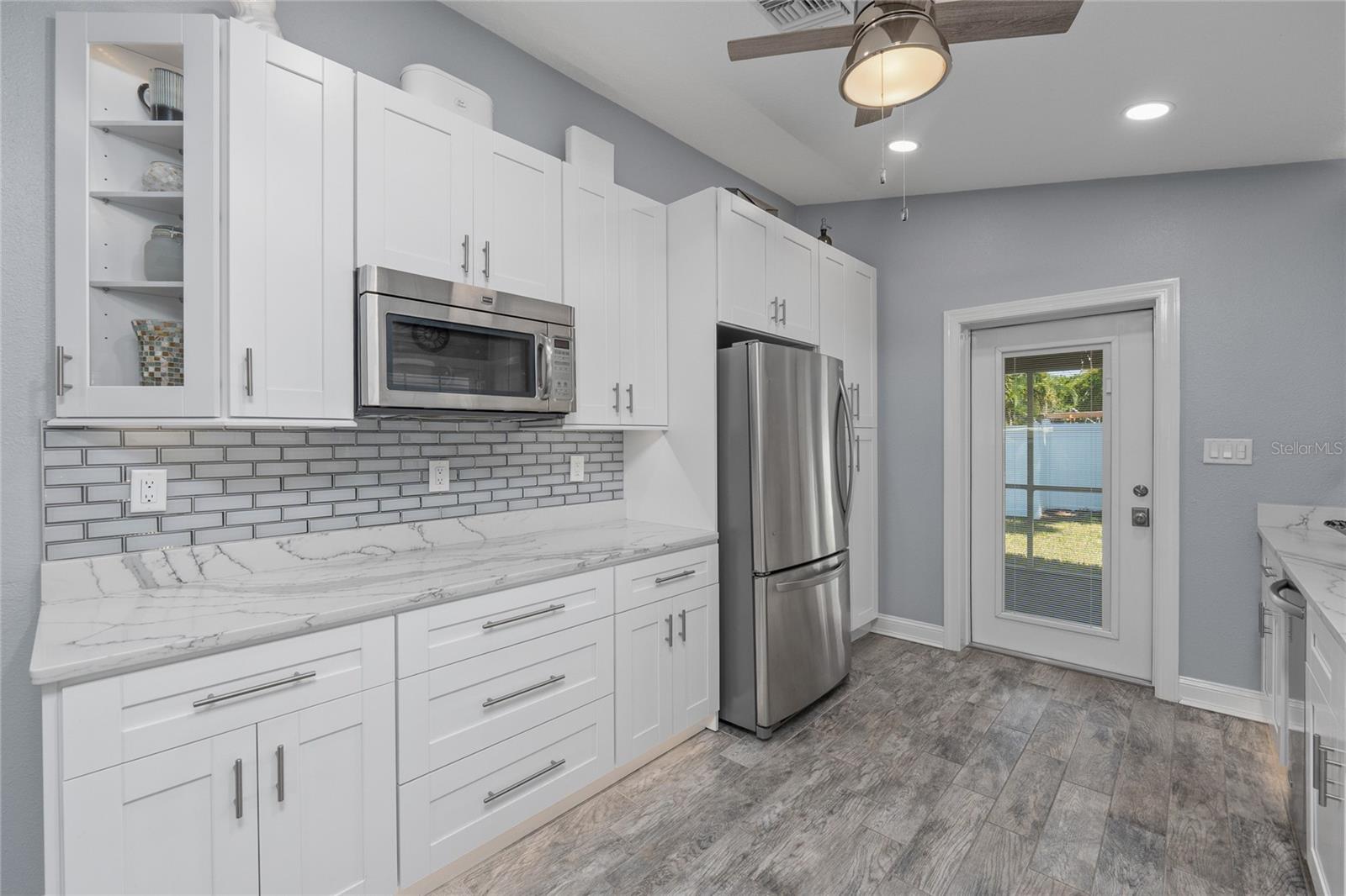 This home has the cutest kitchen that was designed with quartz countertops, stainless steel appliances and beautiful tile flooring throughout