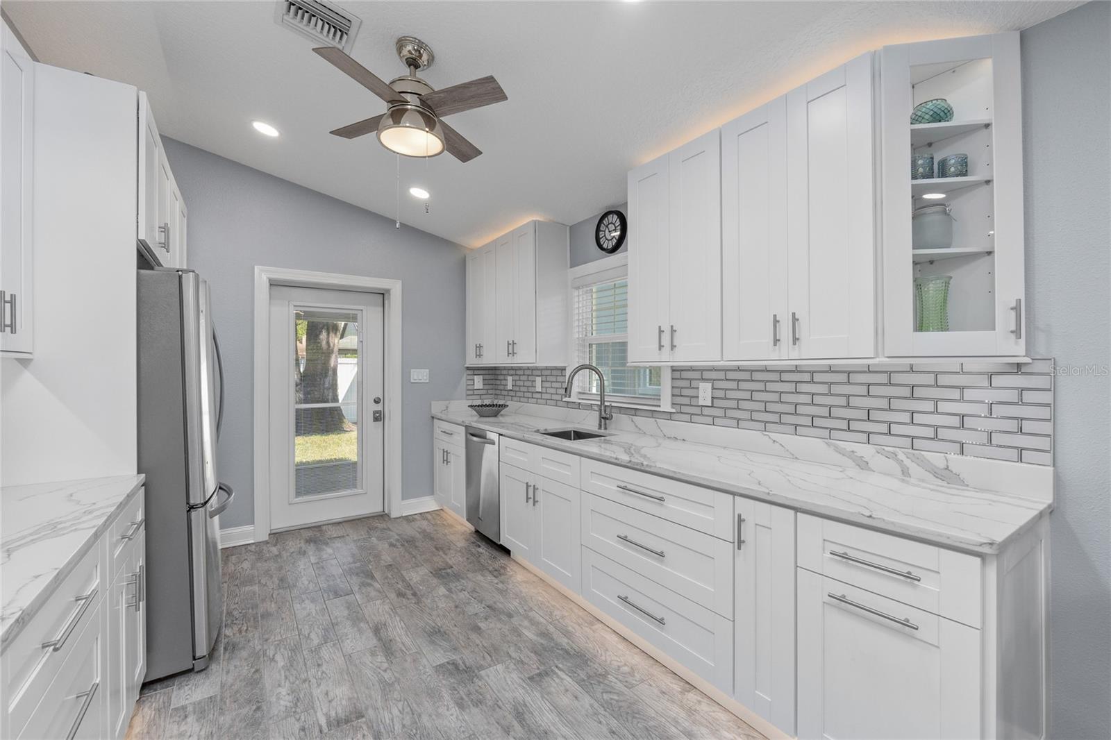 So much storage with all of this cabinetry accented by a subway tile backsplash