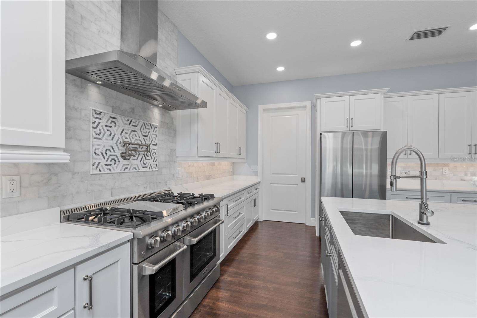 Amazing Thor Range with oversized hood, pot filler and decorative tile to impress the most discerning home chef