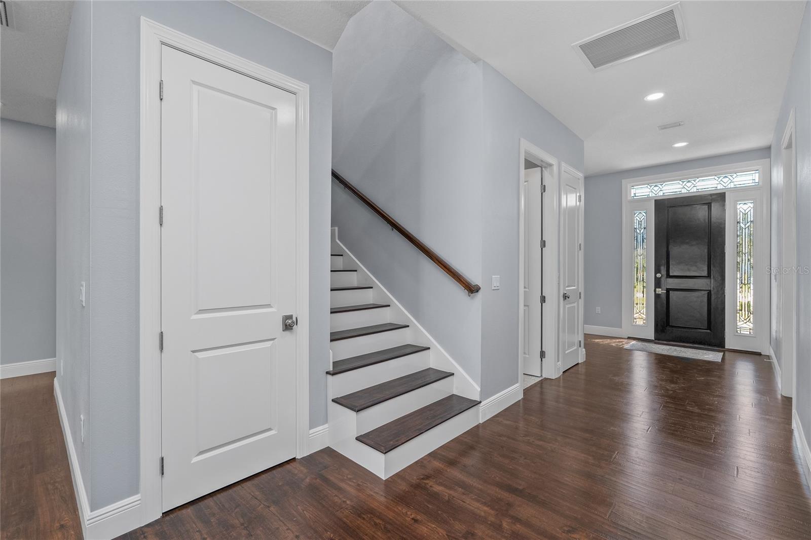 Front door and entry way of the home with beautiful flooring throughout