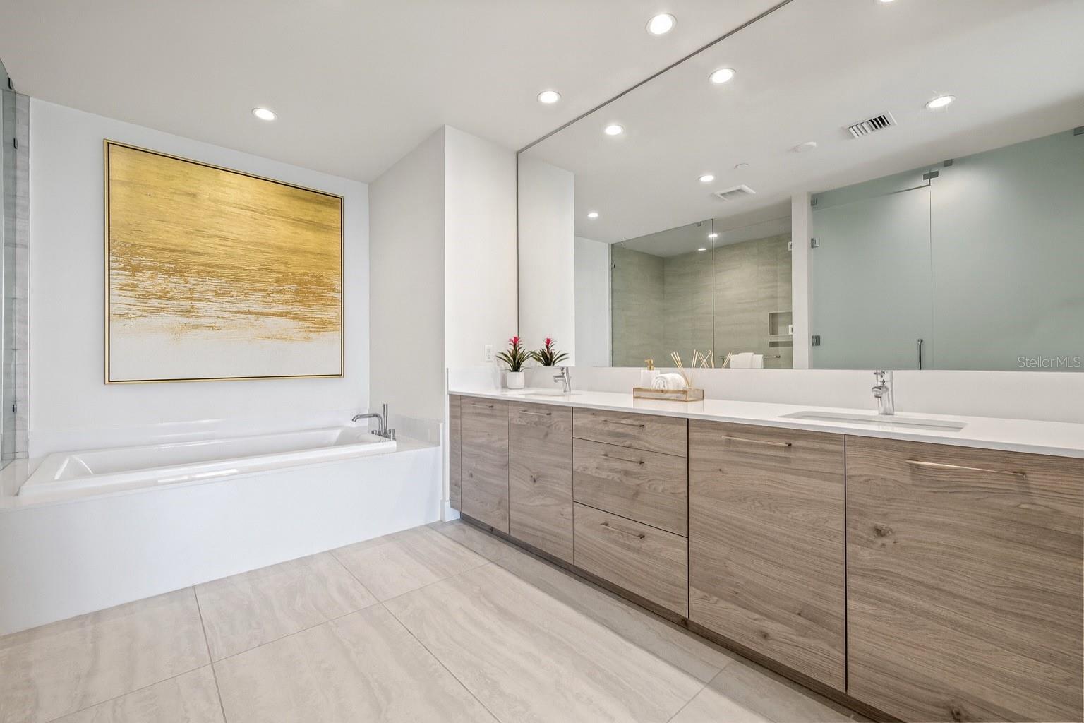 Large Primary Bathroom with 2 sinks and a large soaking tub