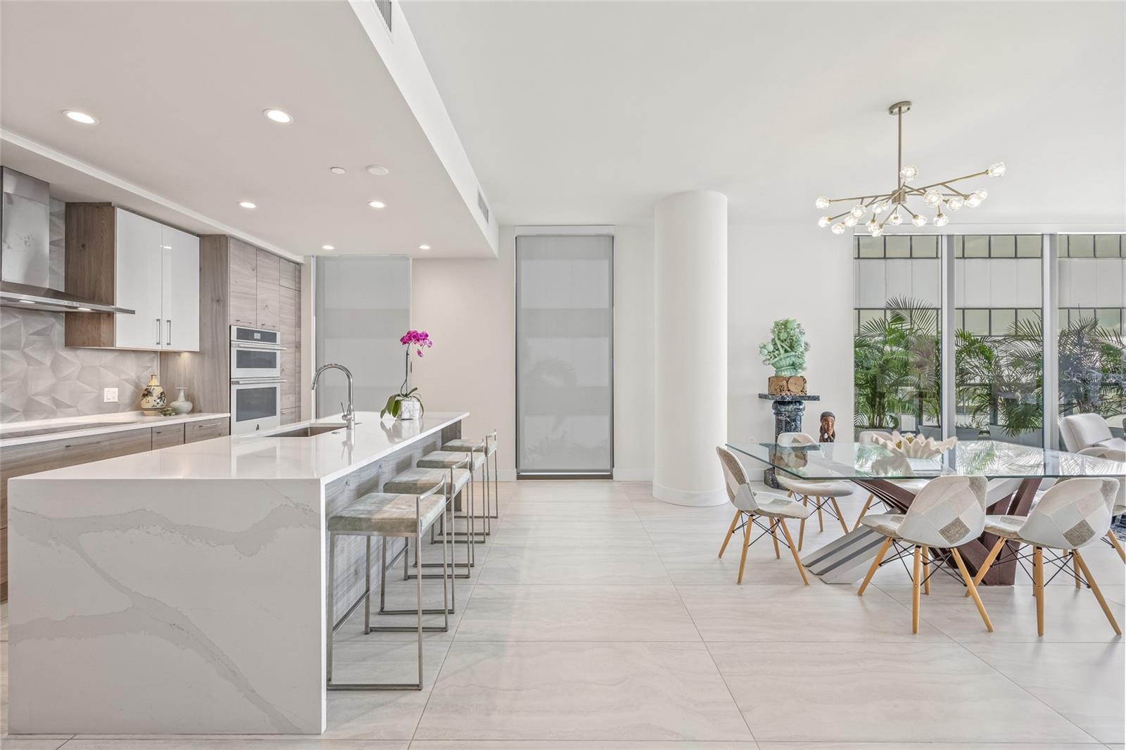 The modern kitchen seamlessly connects to the dining and family rooms, creating an ideal space for entertaining.