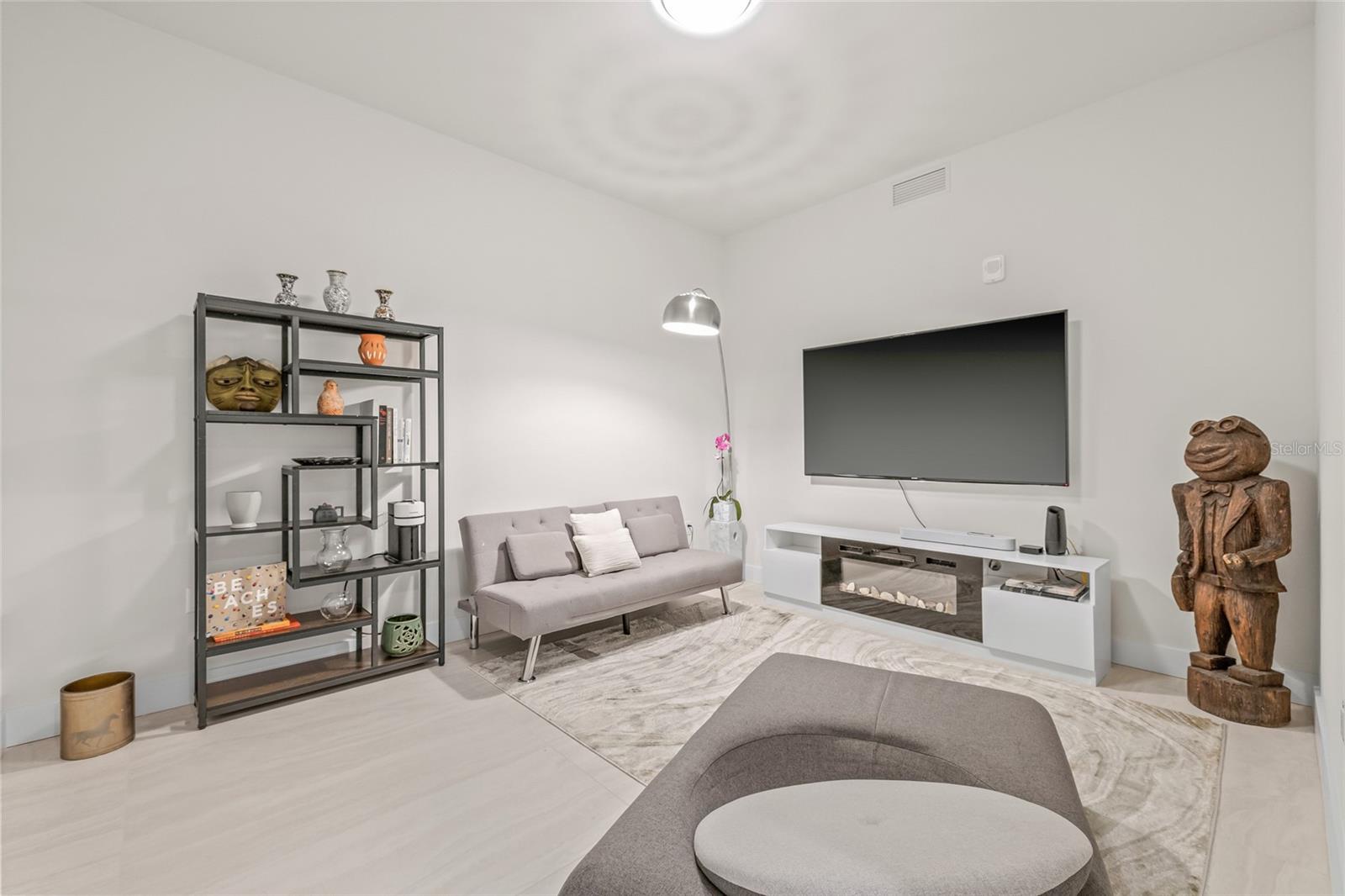 The versatile den offers flexible use as a home office, media room, or fitness space.