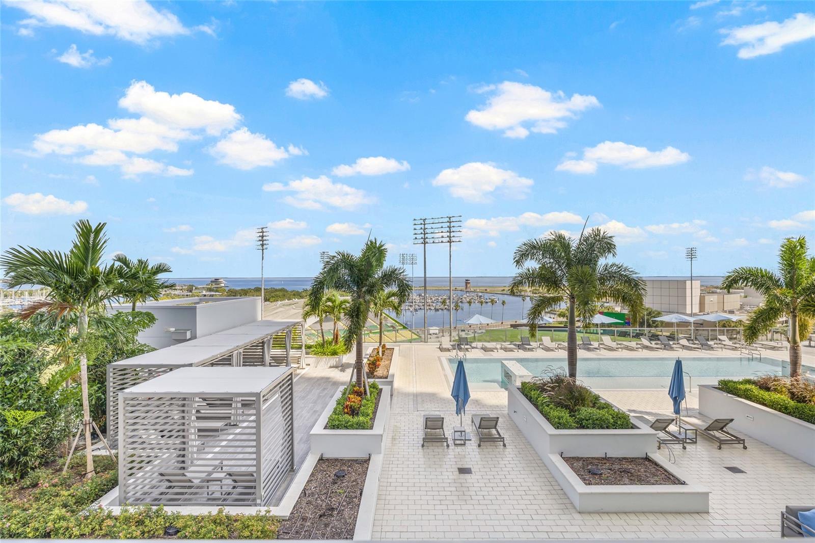 The pool deck offers inviting cabanas, a relaxing spa surrounded by lush landscaping, and outdoor grills—all with a fantastic view.