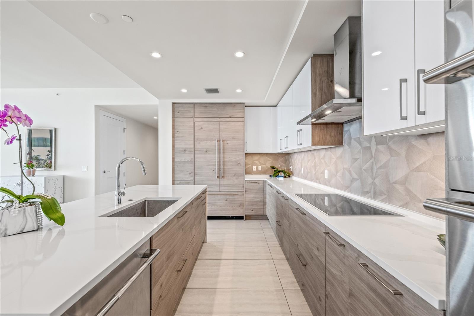 A well-appointed kitchen with Jennair appliances, including a paneled refrigerator and dishwasher.