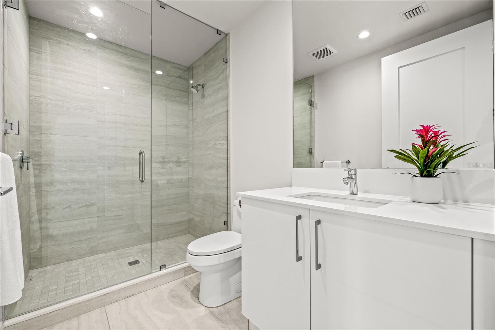 The en suite bath for Bedroom #3 includes a sleek walk-in shower