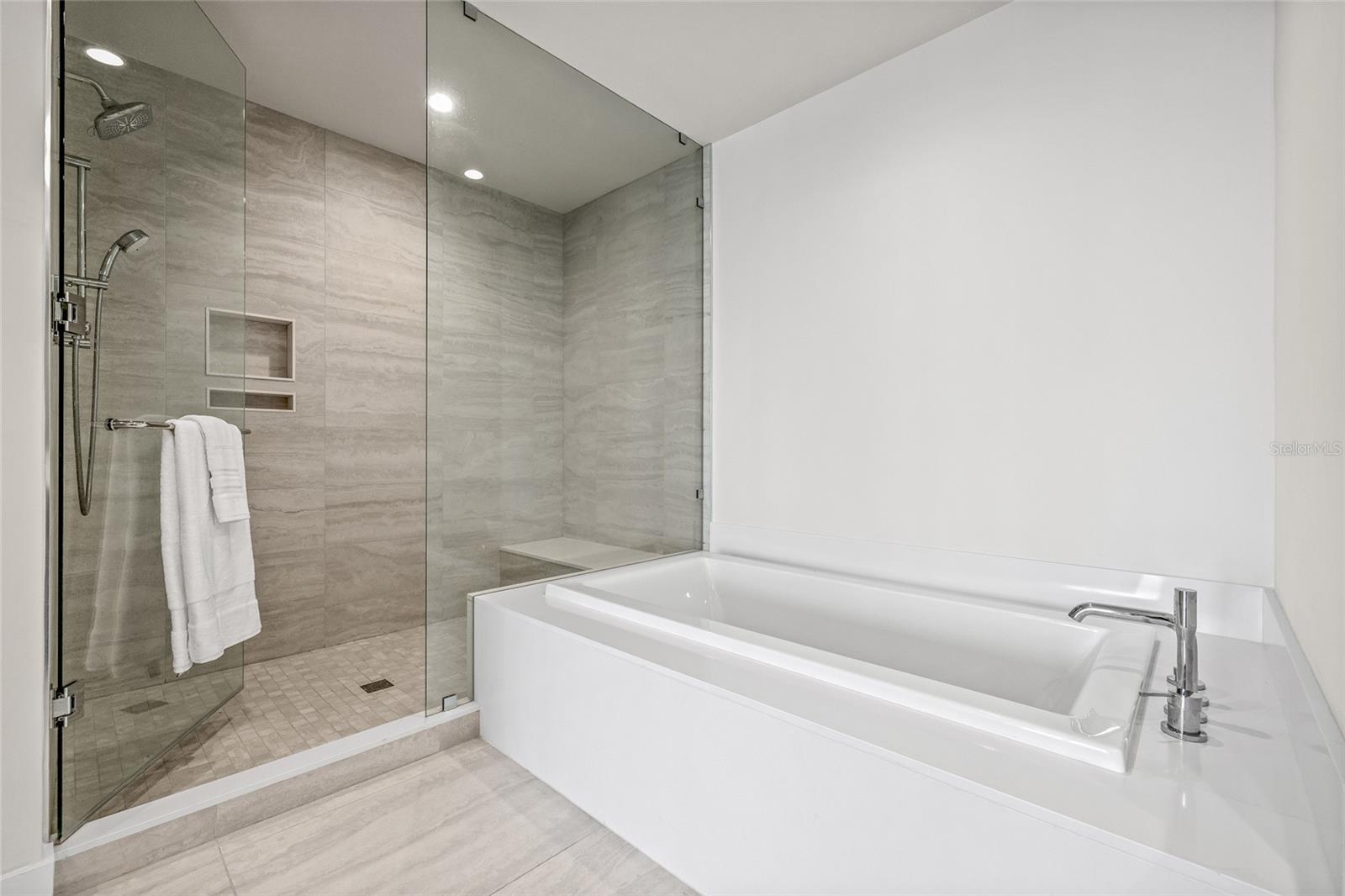 The spa-like bath features a spacious walk-in shower and a relaxing soaking tub.