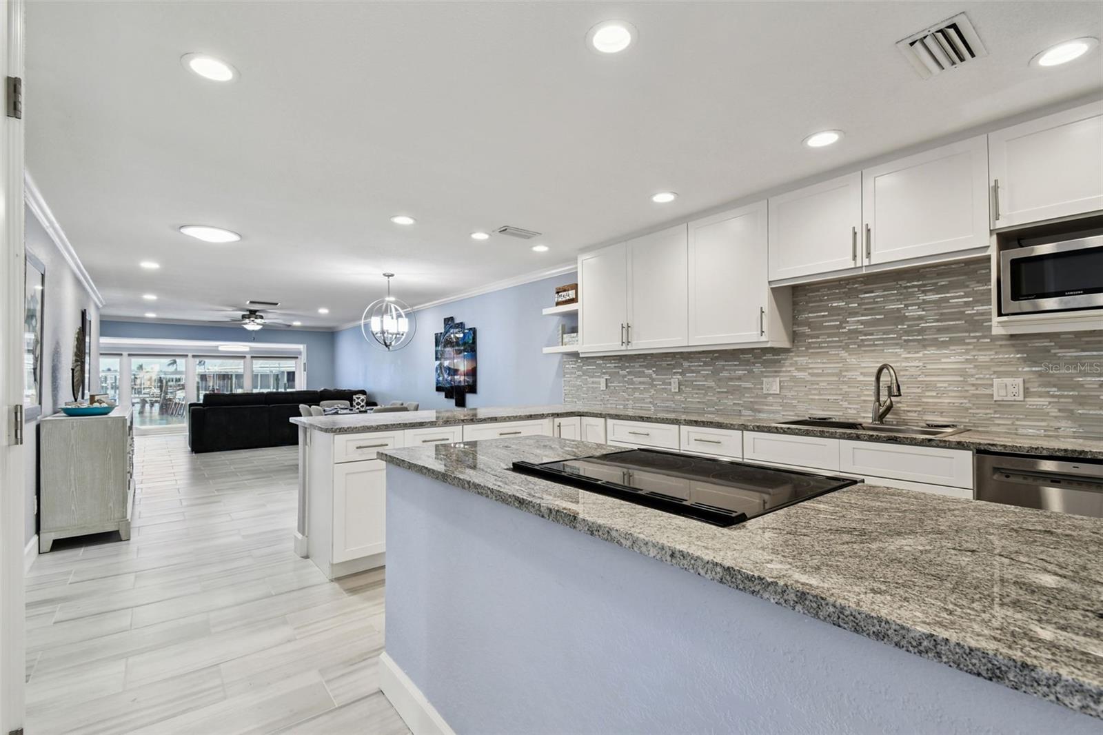 Entrance to the updated kitchen complete with stone countertops and decorative backsplash.