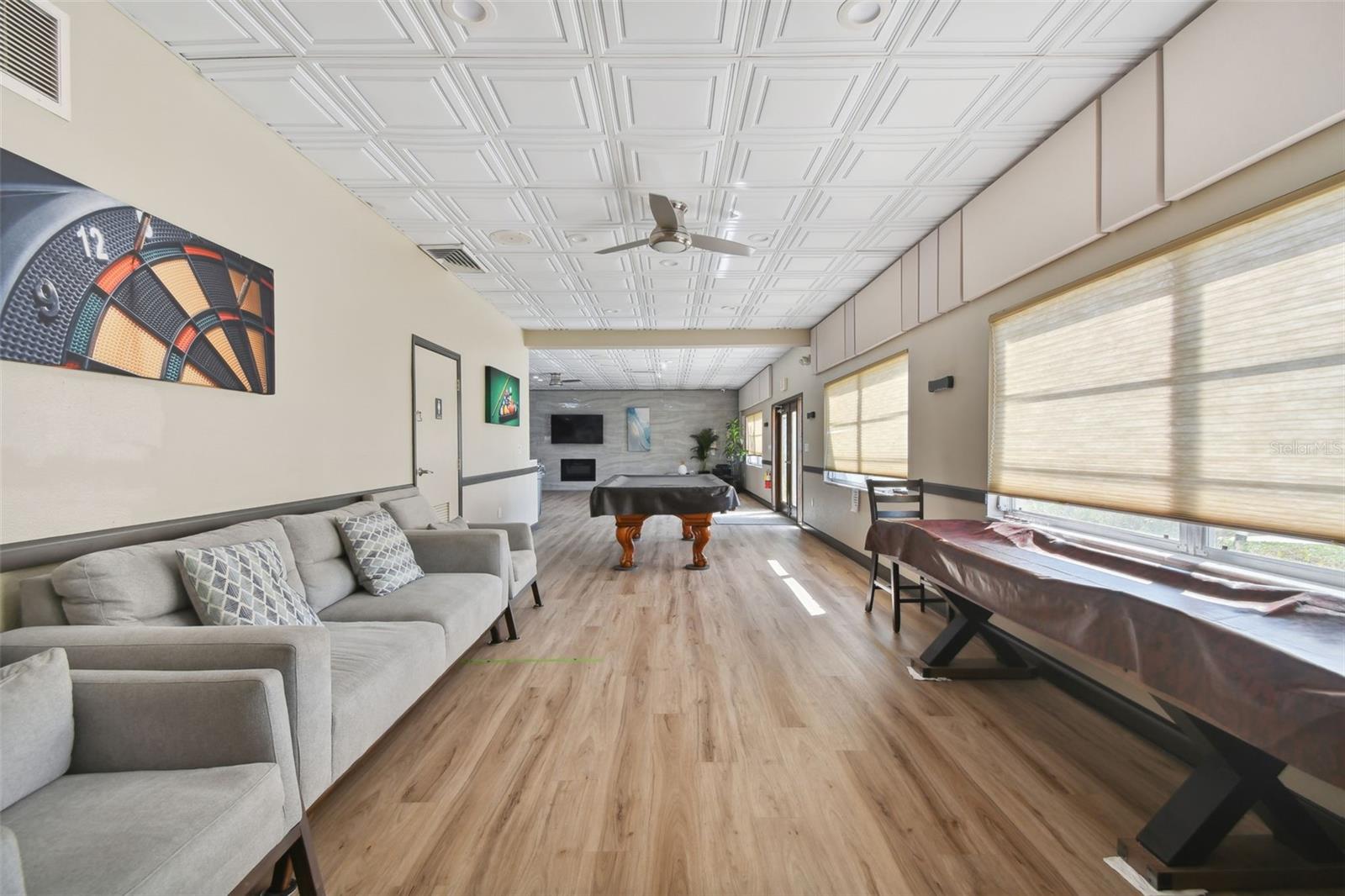 Clubhouse amenities with pool table and shuffleboard table.