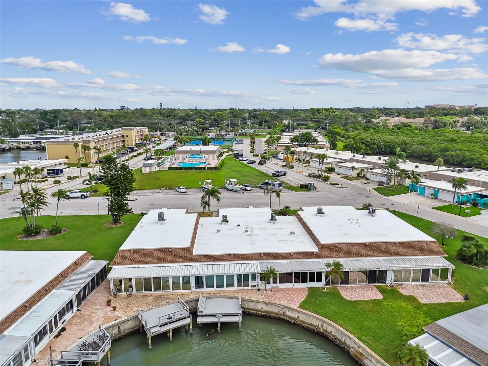 Aerial view of back dock and clubhouse and pool across conveniently located across the street.