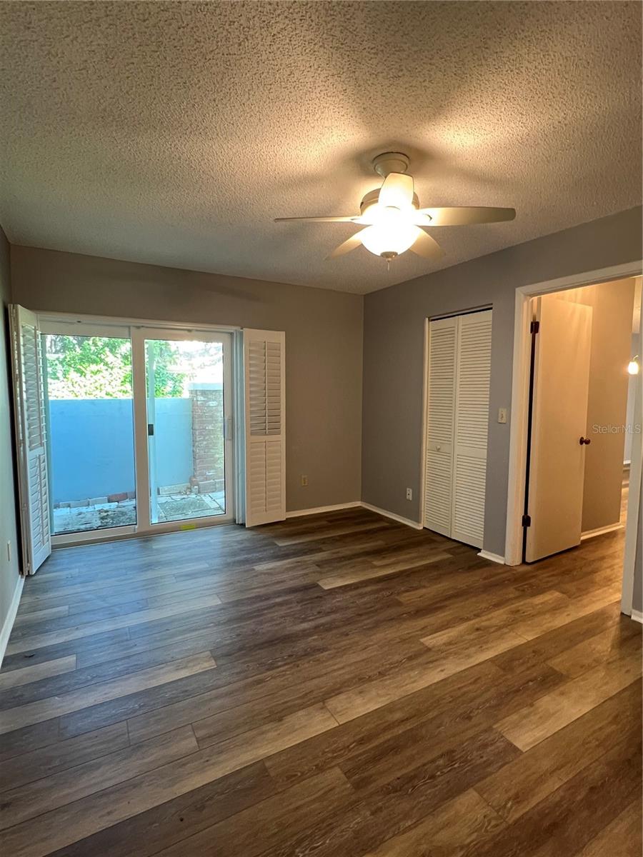 Bedroom facing sliders to yard