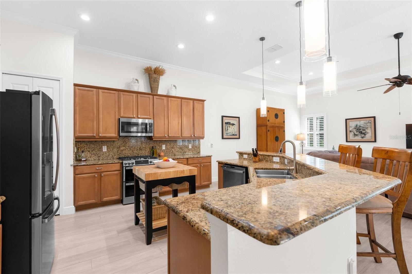 Large open kitchen with granite countertops, real wood cabinets and "Profile" GE appliances.