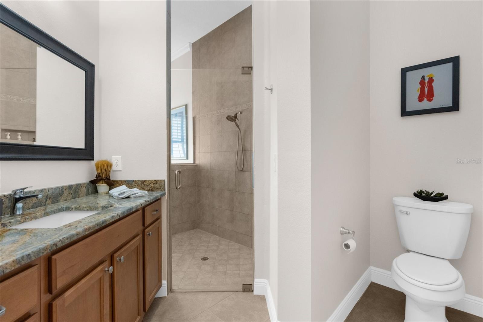 Master suite: "His" bath area with access to shower and "his" private closet.