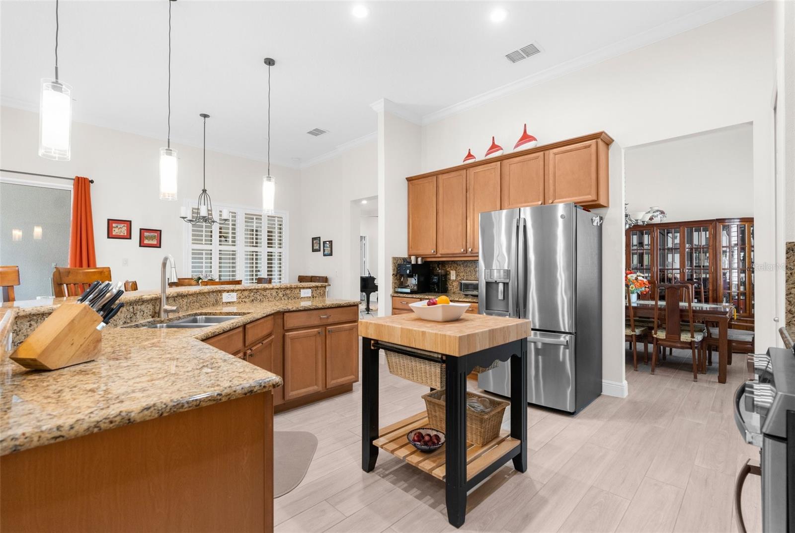 Large open kitchen with granite countertops, real wood cabinets and "Profile" GE appliances.