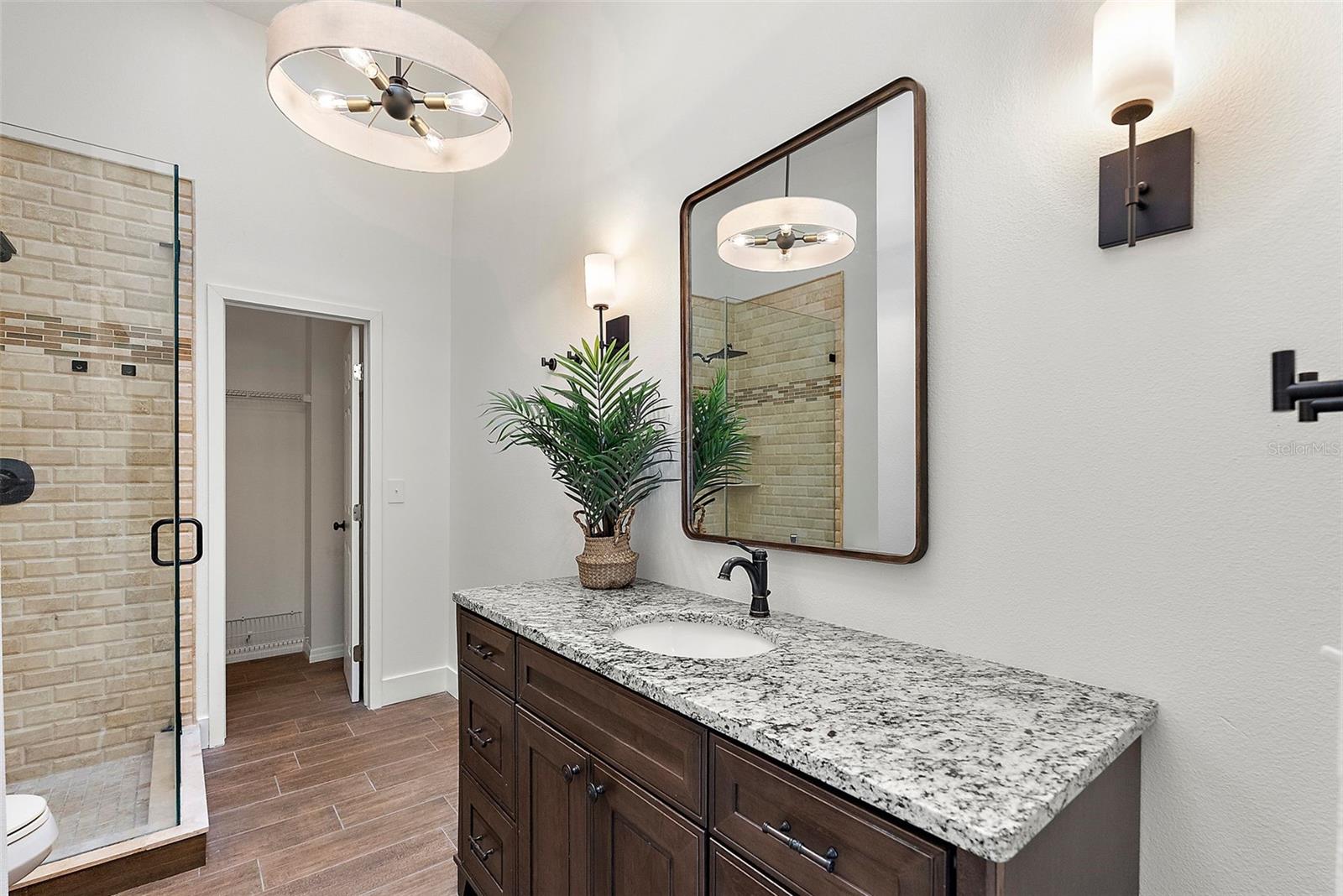 Primary bath that features two closets, one with built in drawers.