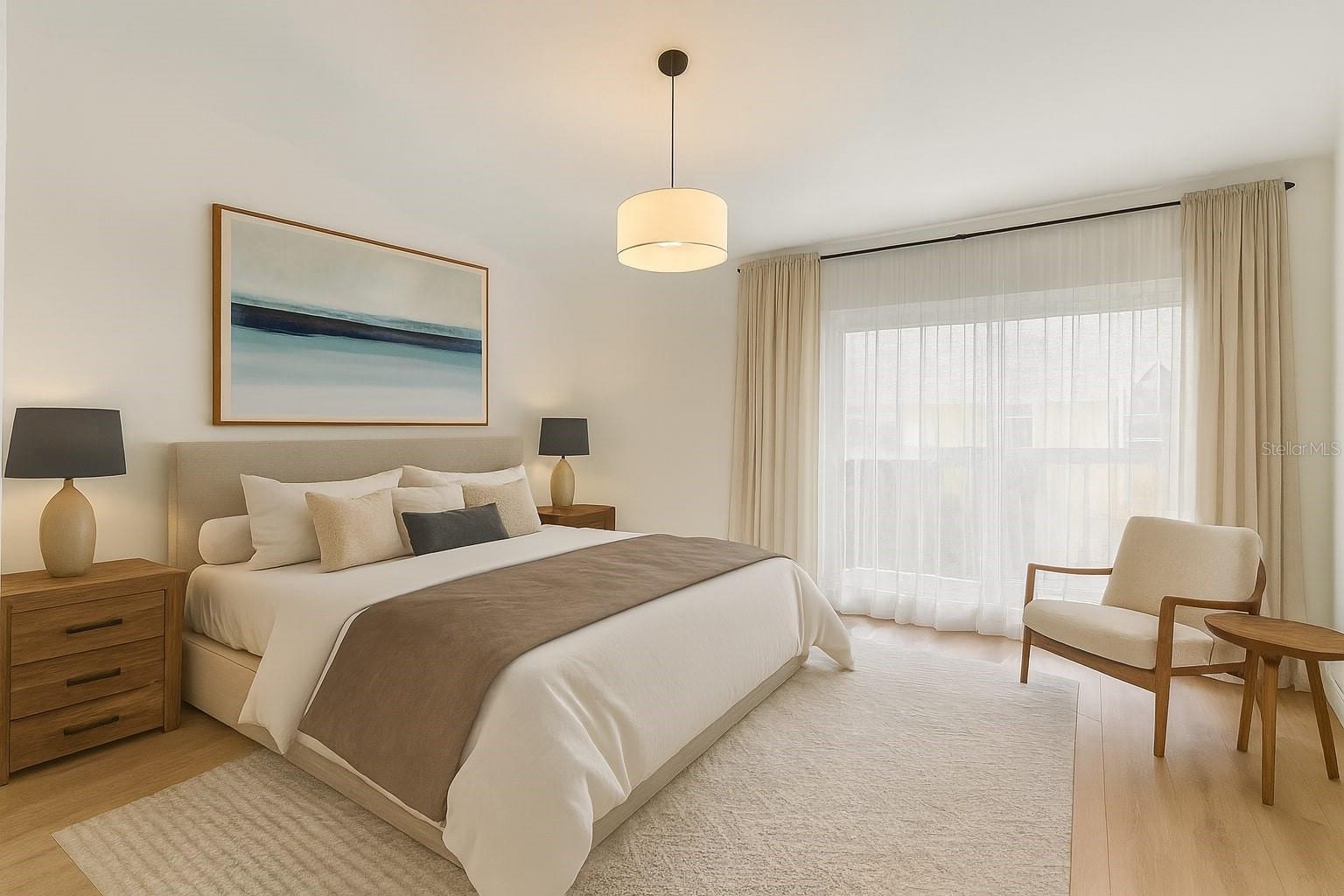 Spacious primary bedroom with balcony and en-suite bath.