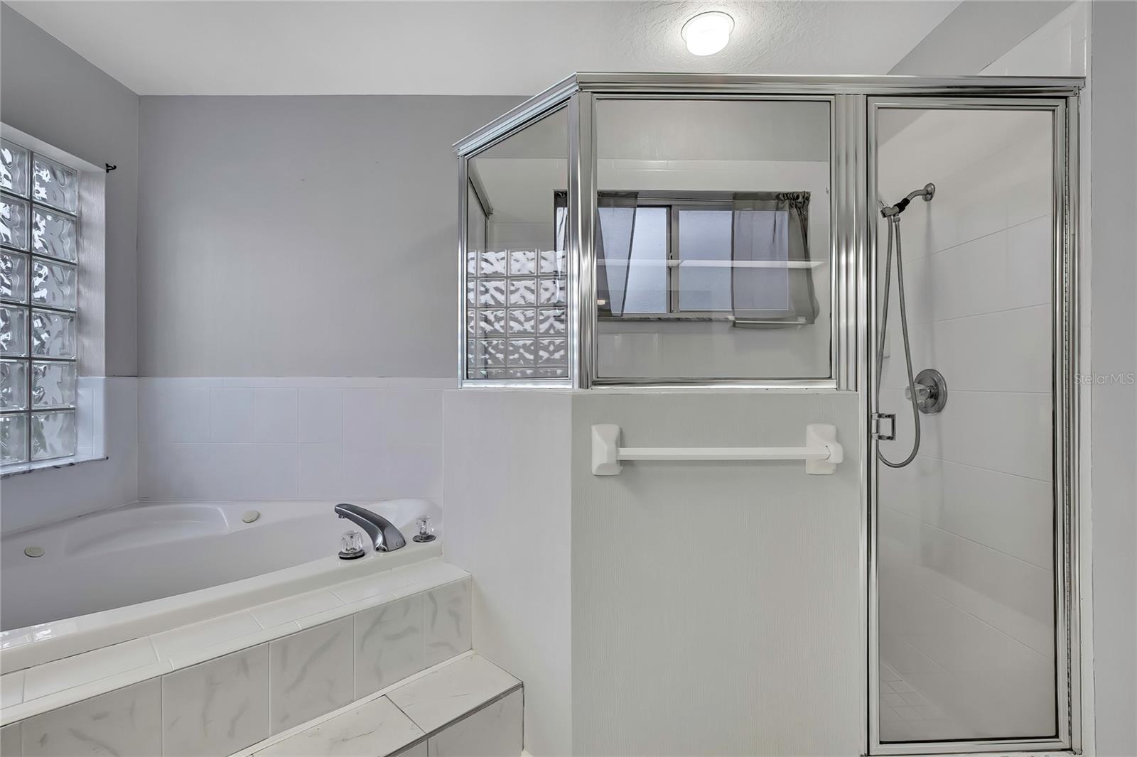Primary bathroom has jetted garden tub and separate walk in shower.