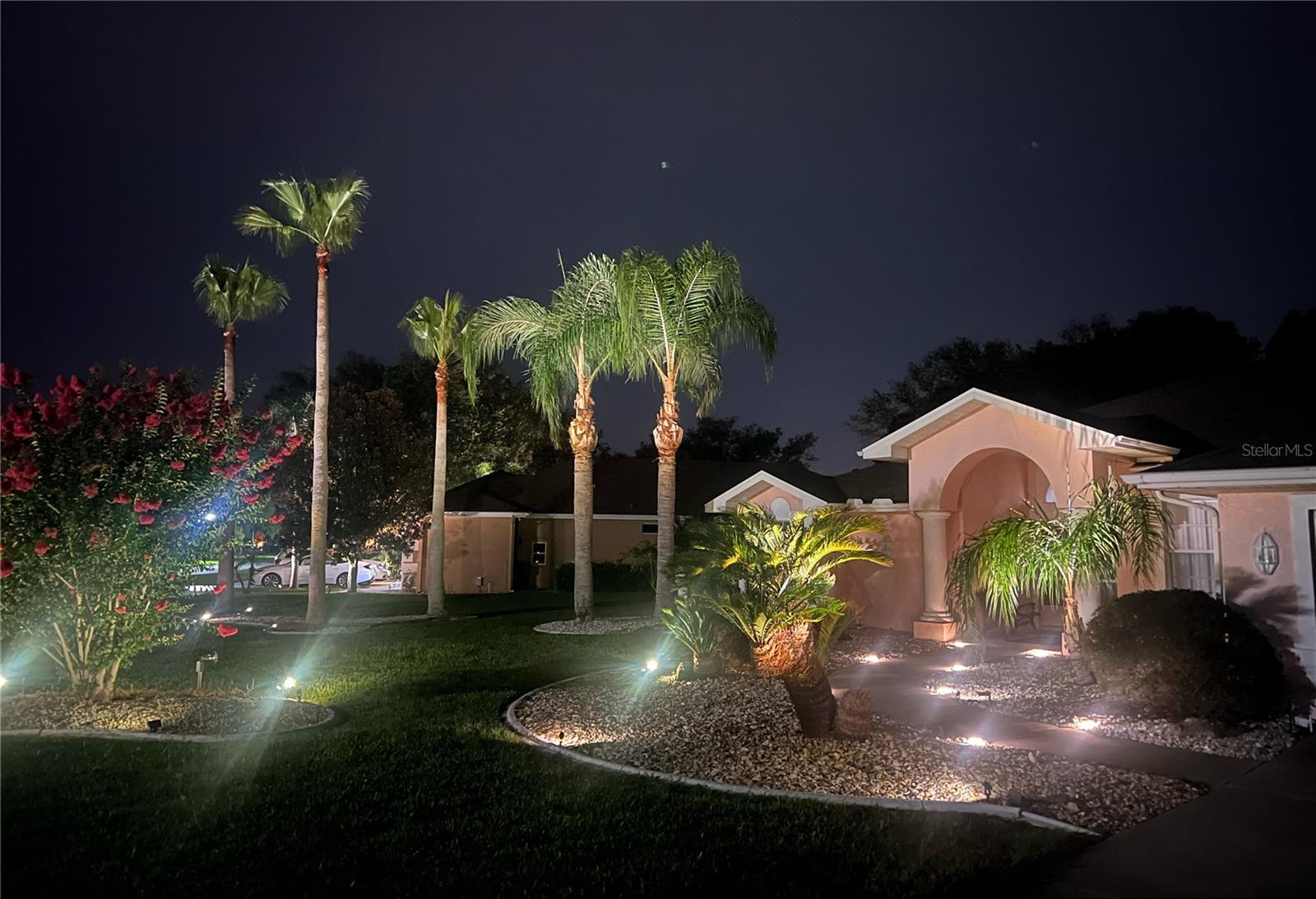 Front at night has lovely accent lighting.  This is a Pristine Place neighborhood tradition which makes this a very nice Florida oasis to live in.