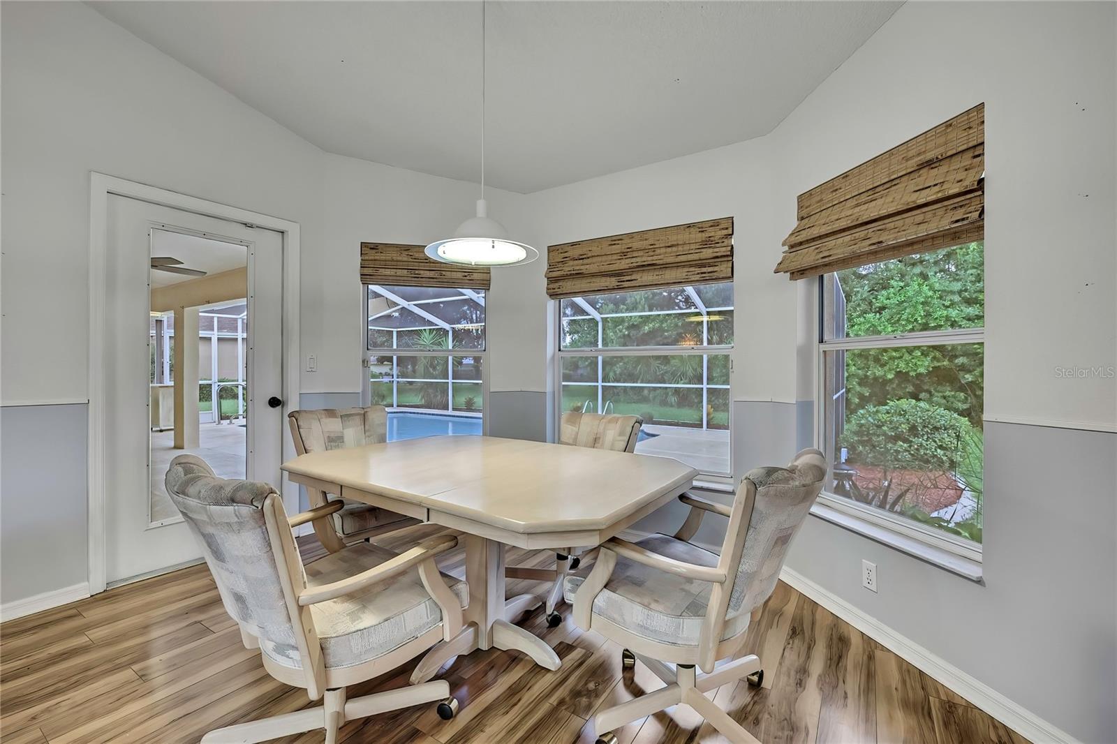 Kitchen nook has a pool view with exit to pool lanai