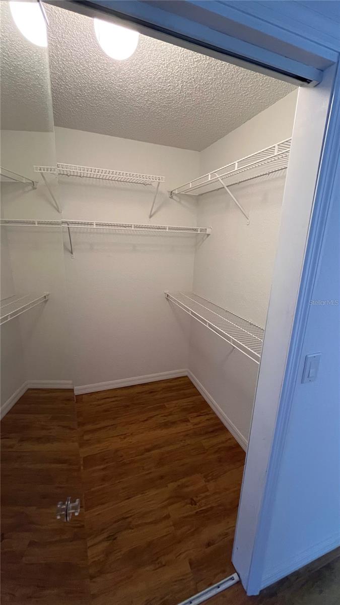 Spacious primary bedroom walk in closet