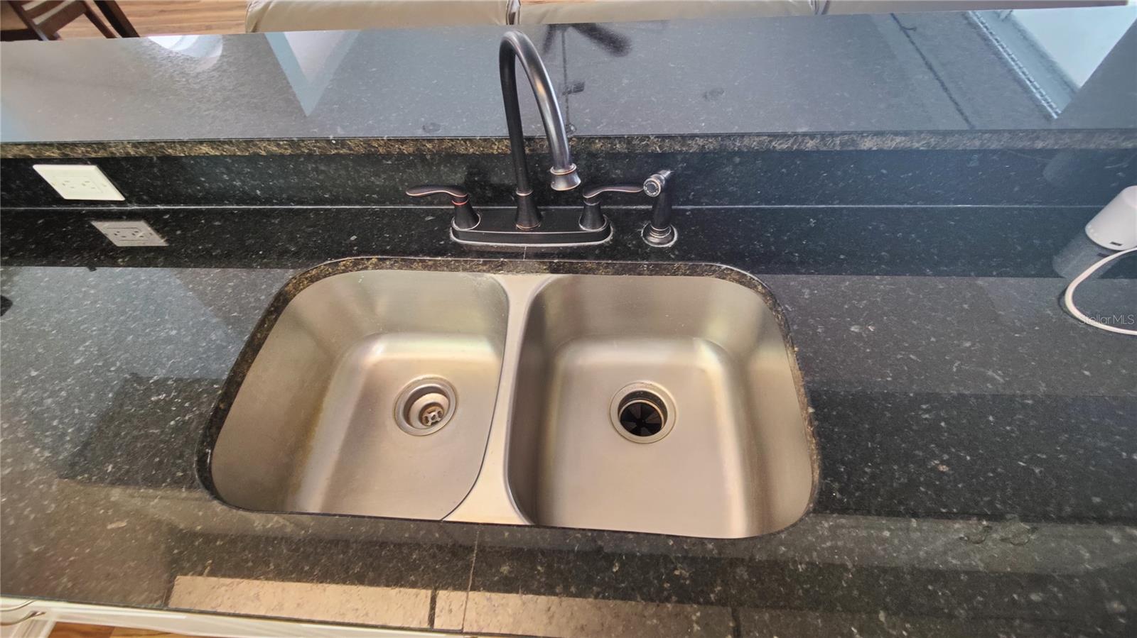Deep stainless steel double sink has a garbage disposer and a high arch faucet and sprayer that makes cooking and cleanup a breeze.  This can also serve as a breakfast or wet bar with stool seating in the great room perfect for entertaining.