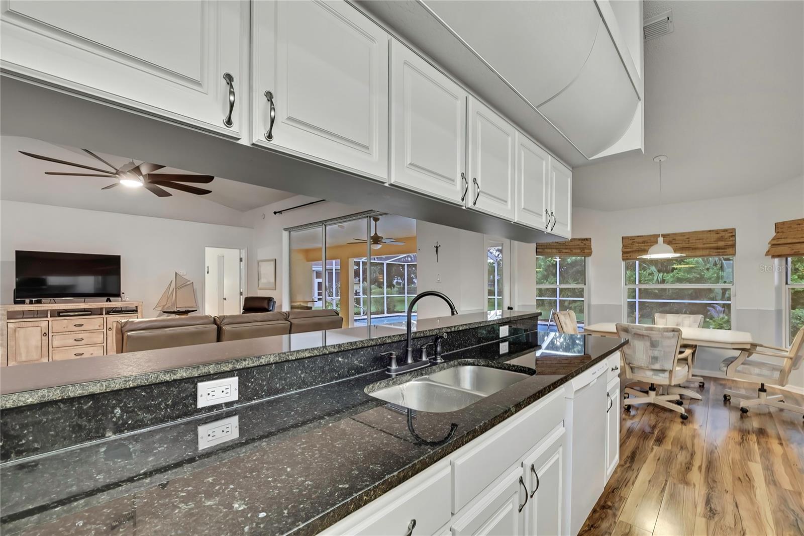 View of breakfast bar, open concept great room, breakfast nook, pool and lanai.