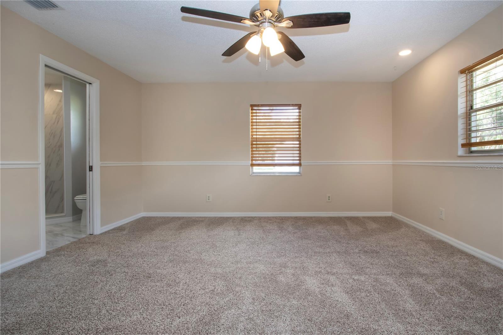 Primary bedroom with pocket door to the bathroom
