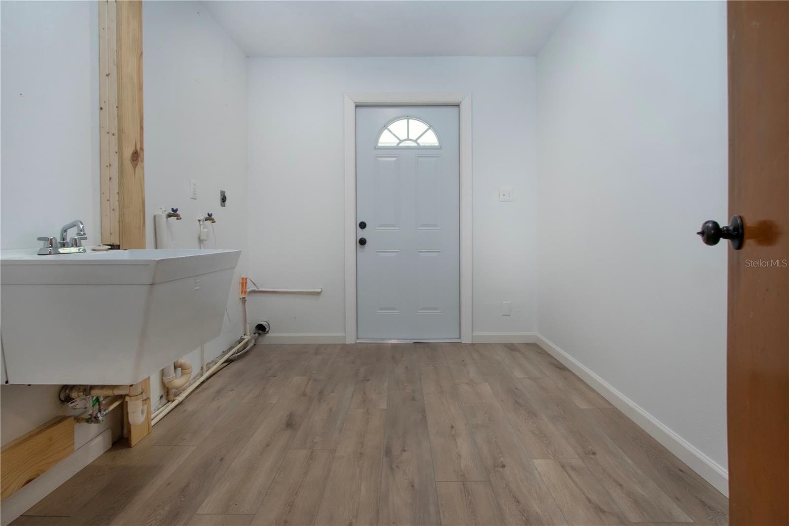 Laundry and utility room with a door that leads outside
