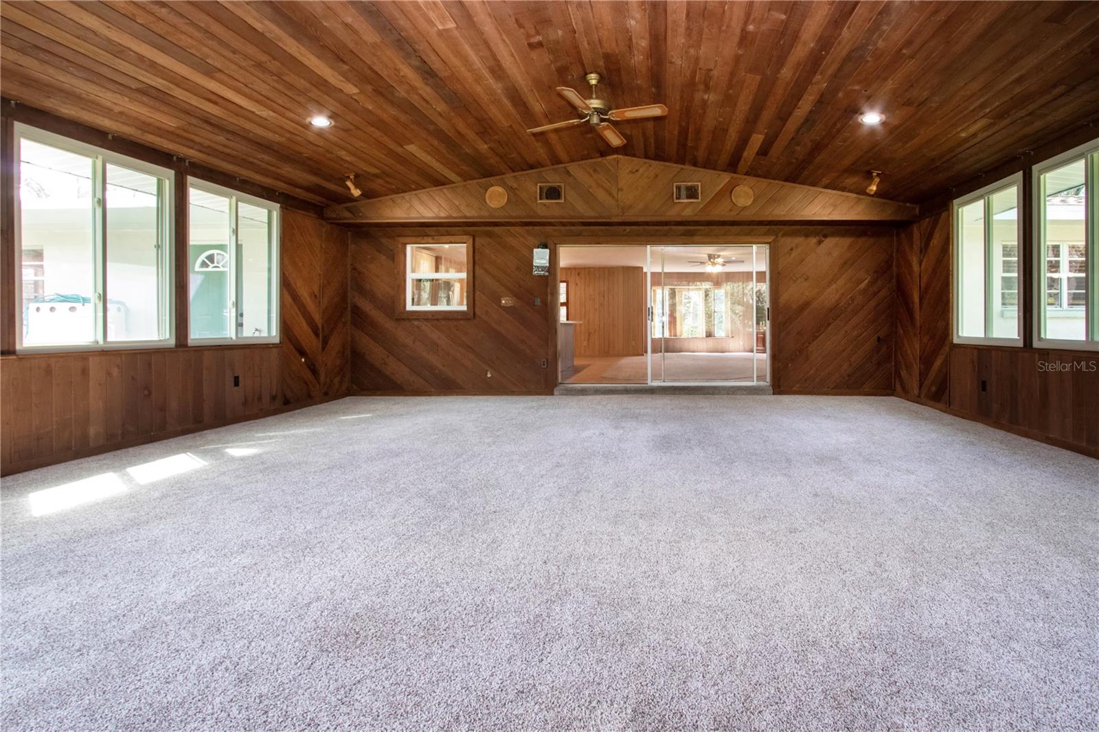 Air conditioned and new carpeting in Florida room with sliding glass doors to the living room