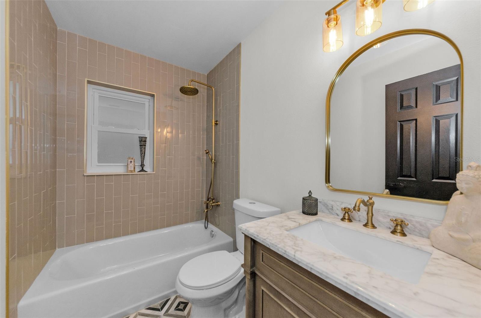 GUEST BATH WITH NEW VANITY, QUARTZ TOP, NEW MIRROR, LIGHTING, ANTIQUE BRASS FAUCET, NEW BATHTUB SURROUND TILE, AND LOOK AT THE NEW SHOWER BODY!