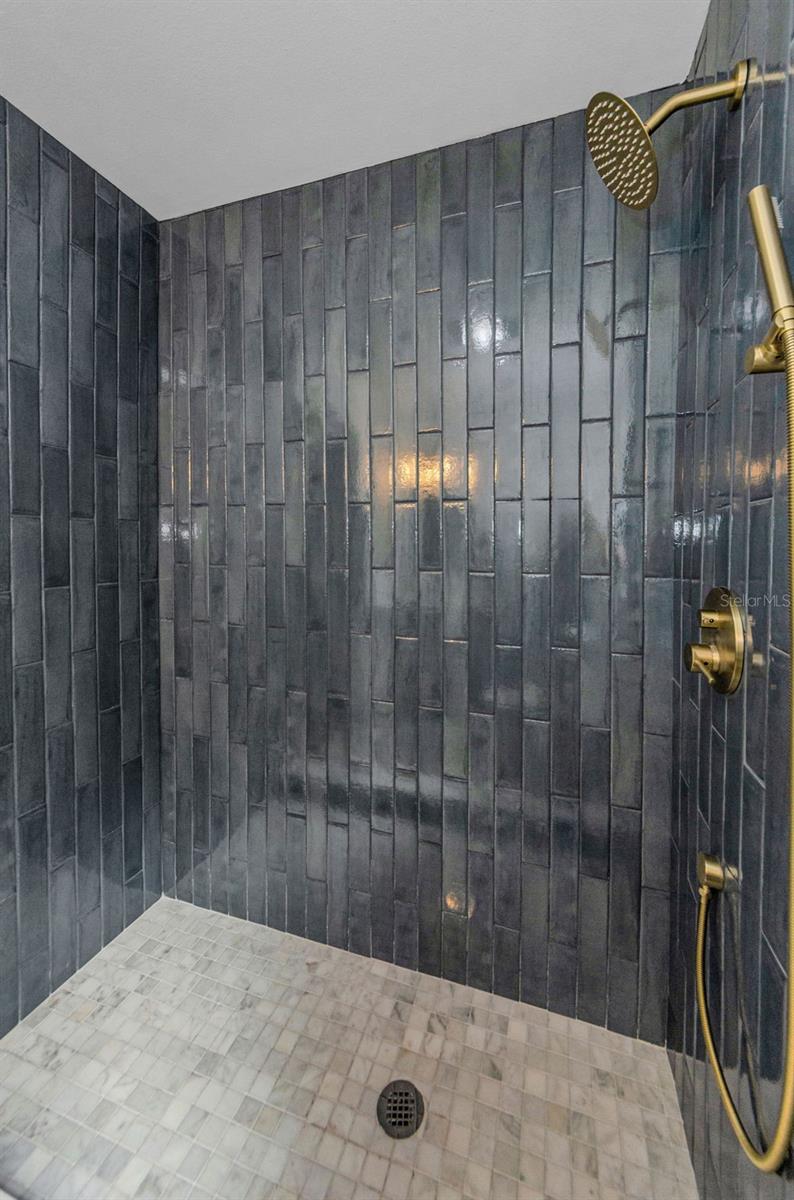 STOP THE CAR! LOOK AT THIS SPECTACULAR WALK IN SHOWER! GORGEOUS TILE SURROUND, ANTIQUE BRASS SHOWER BODY, MARBLE FLOOR!