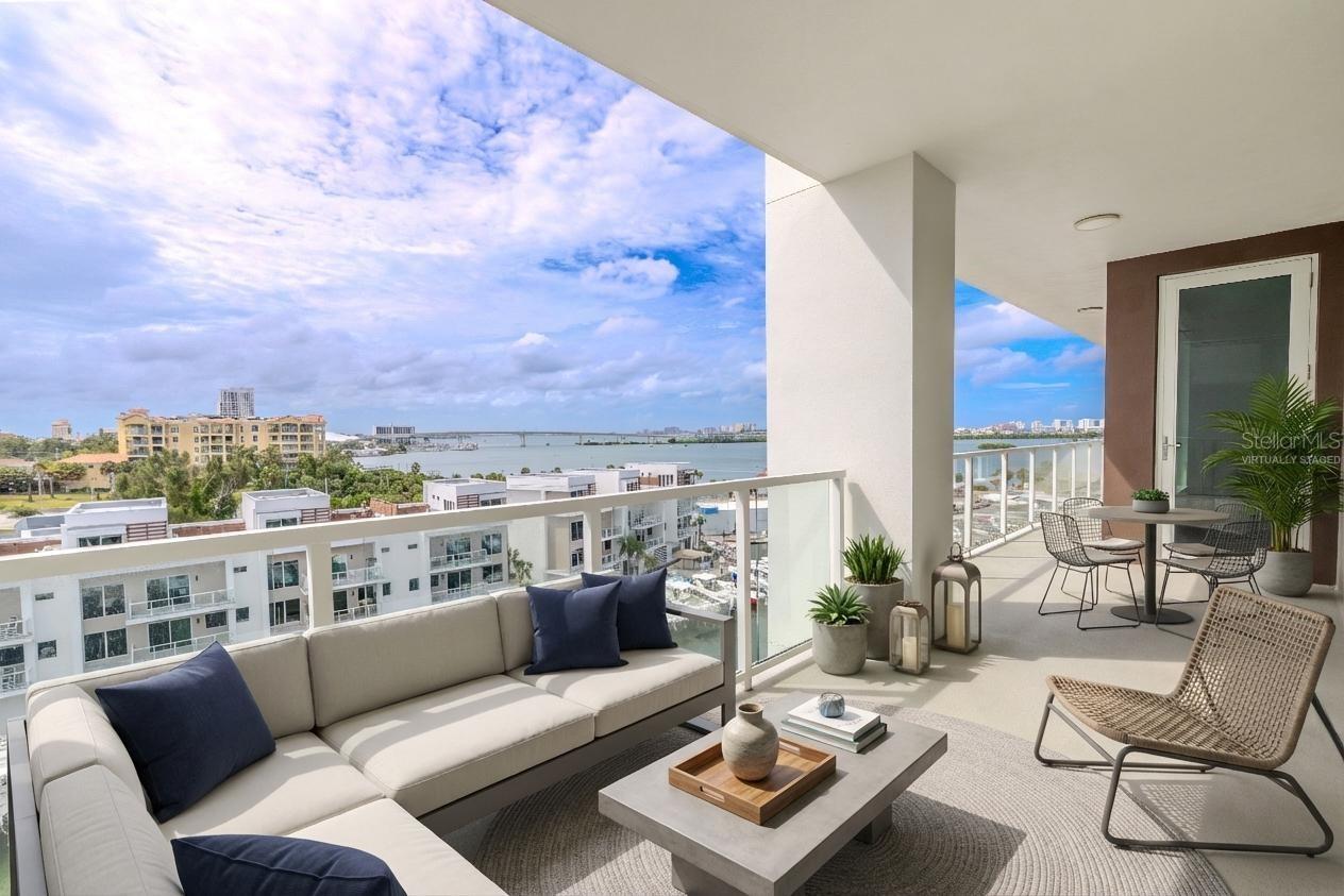 Perfect for morning coffee or evening cocktails, the balcony offers the ultimate setting to soak up the Gulf breeze and panoramic waterfront vistas. Virtually staged photo.