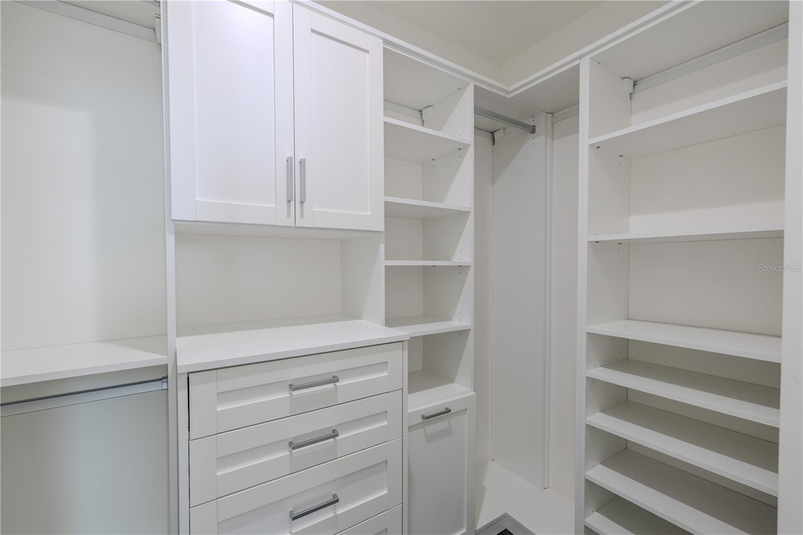 Bedroom 3 walk-in closet is thoughtfully designed with built-in shelving, drawers, and hanging space, providing both beauty and function. Soft-close cabinetry, modern hardware, and ample storage make organization effortless.