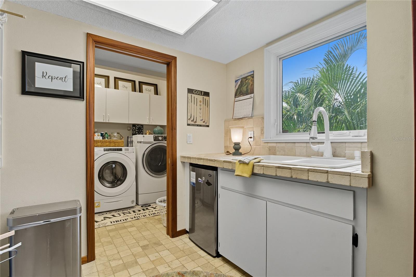 LAUNDRY ROOM WITH UTILITY SINK, AN EXTRA FRIDGE AND ADDITIONAL STORAGE SPACE YOU CAN'T BEAT!