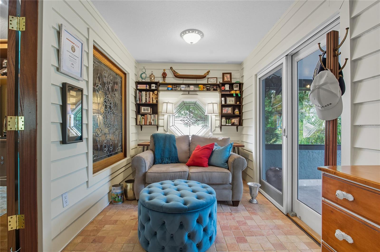 FLORIDA ROOM THAT LEADS OUT TO THE ROOFTOP PATIO