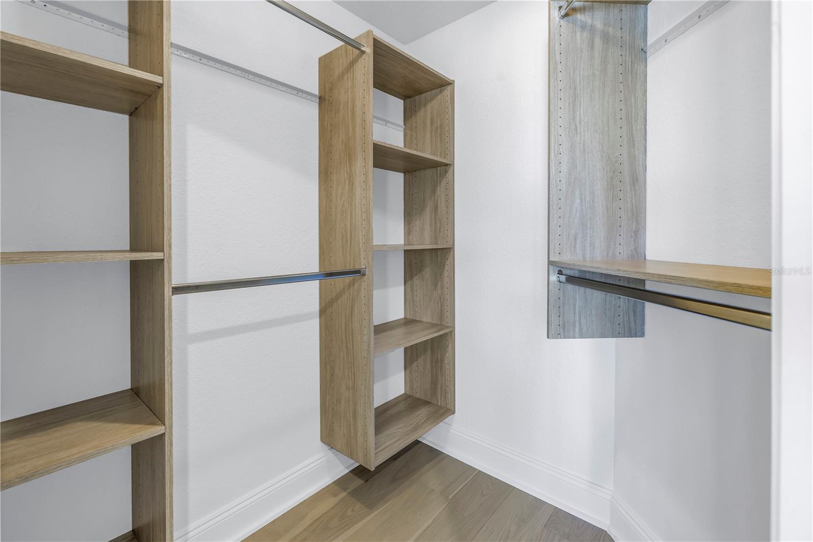 Primary bedroom walk in closet